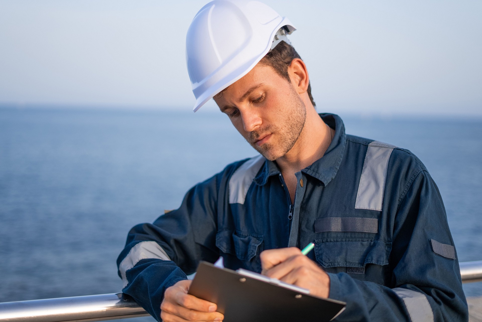 Engineer with clipboard working in port